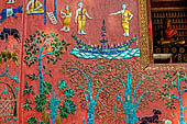 Wat Xieng Thong temple in Luang Prabang, Laos.  La Chapelle Rouge , the Red Chapel. The exterior walls are decorated with colourful mosaics on a pink background with scenes of people daily activities. South wall. 